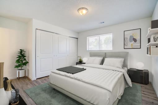 a bedroom with a white bed and a large white door