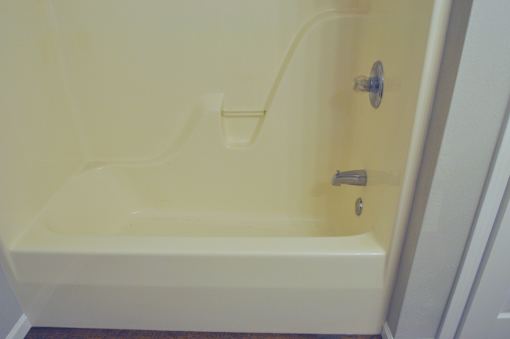 A white bathtub with a silver faucet and handle.