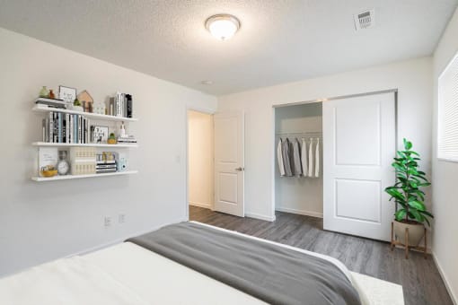a bedroom with a bed and a closet