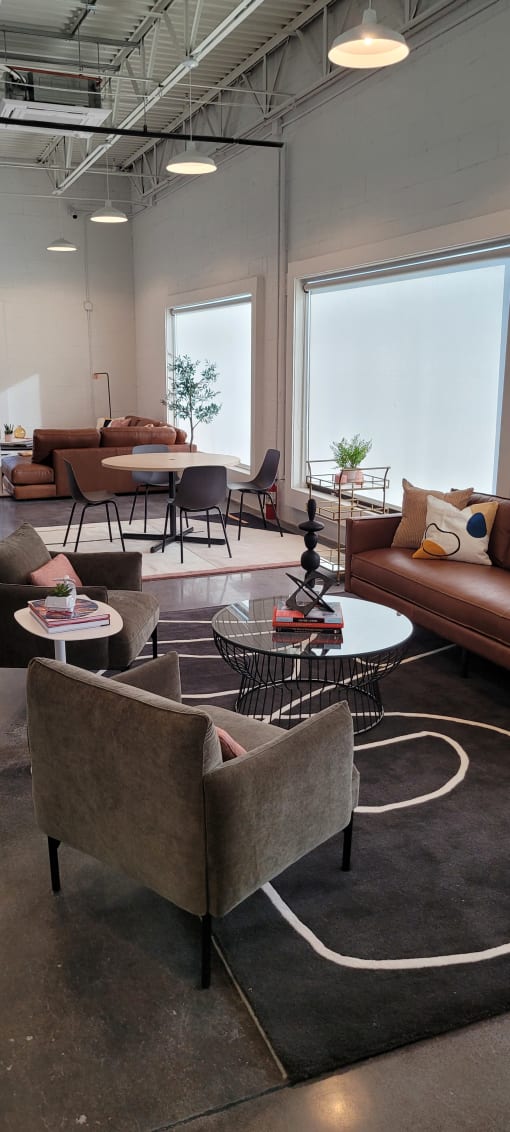 a living room filled with furniture and a large window