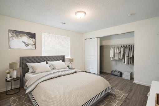 a bedroom with a large bed and a closet