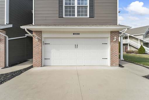 a white garage door on the side of a house