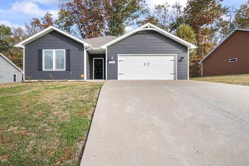 a house with a driveway and a white garage door