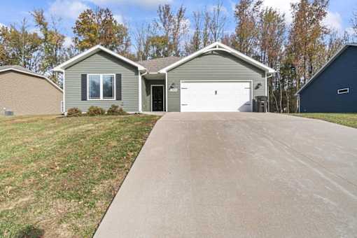 a house with a driveway and a white garage door
