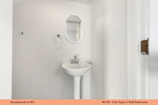 A white sink in a small bathroom.