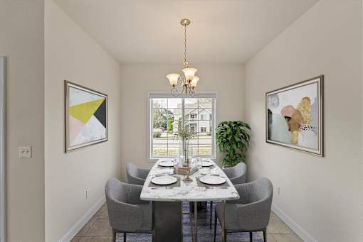 a dining room with a table and chairs and a window