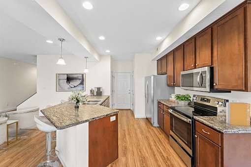 a kitchen with wooden cabinets and stainless steel appliances