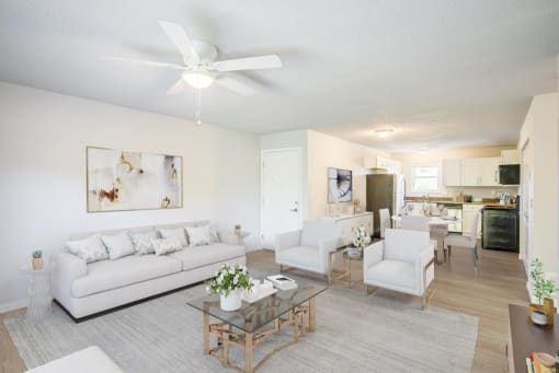 a living room filled with furniture and a ceiling fan