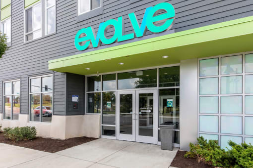 the exterior of an evo store with a green sign above the door