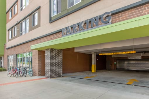the parking garage entrance of a building with bikes parked outside