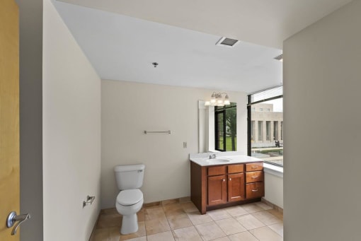 a bathroom with a toilet sink and a window
