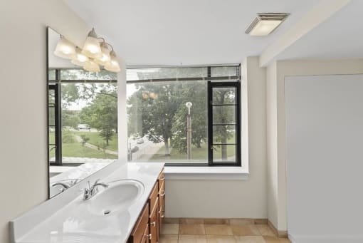 a bathroom with a large window and a sink