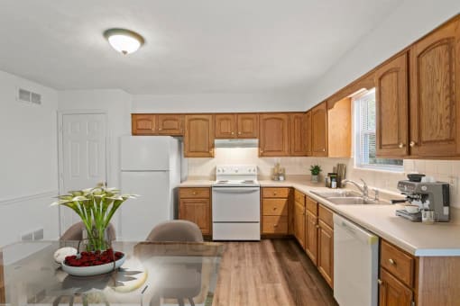 a kitchen with white appliances and wooden cabinets