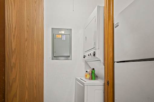 A small kitchen with a white fridge and a white oven.