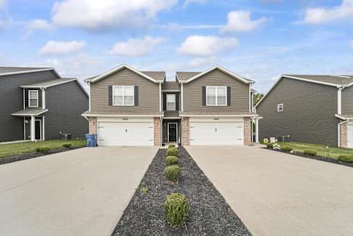 a house with two garage doors and a driveway