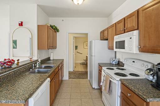 a kitchen with granite counter tops and white appliances