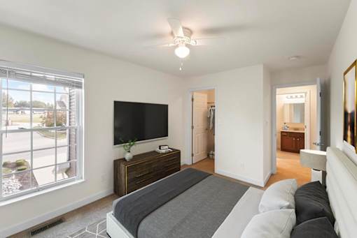 a bedroom with a bed and a tv in it