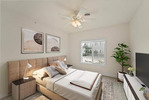 a bedroom with a large bed and a ceiling fan