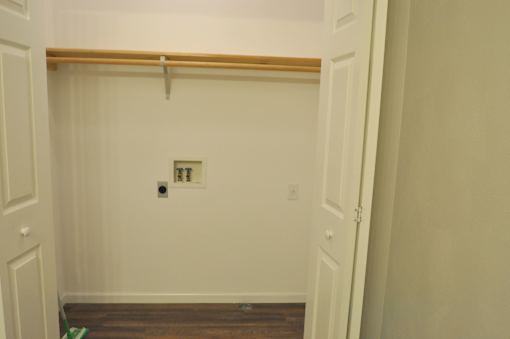A white door with a brown frame is open.