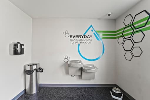 A bathroom with a wall decal that says "Everyday is a good day to work out".