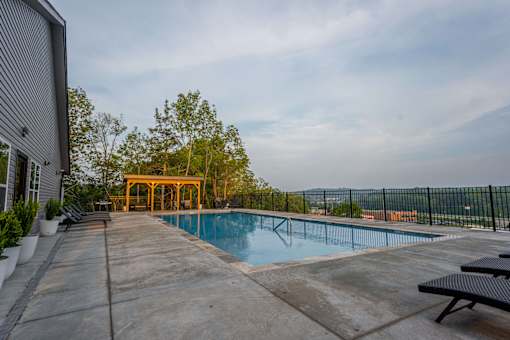 A pool with a yellow structure in the background.
