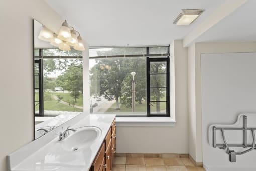a bathroom with a large window and a sink