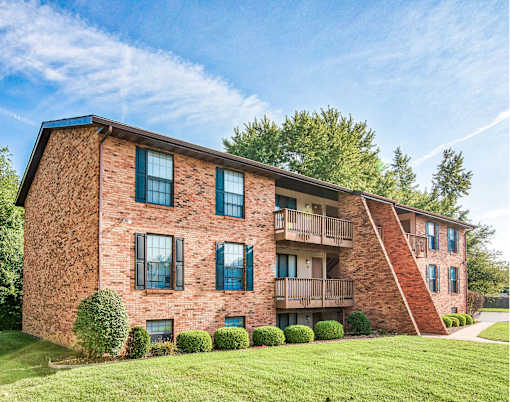 A red brick building with a balcony on the second floor.