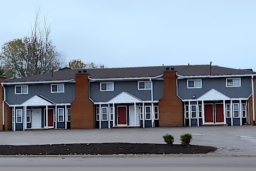 A row of houses with grey and brown exteriors.