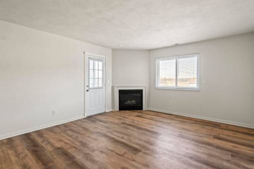 A room with a fireplace and a window.