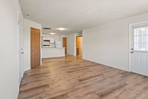 A room with wooden floors and white walls.