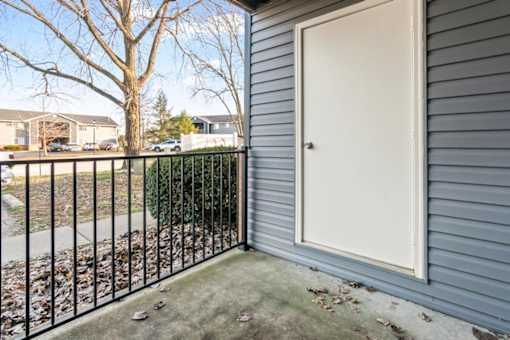 A white door is on the side of a house.
