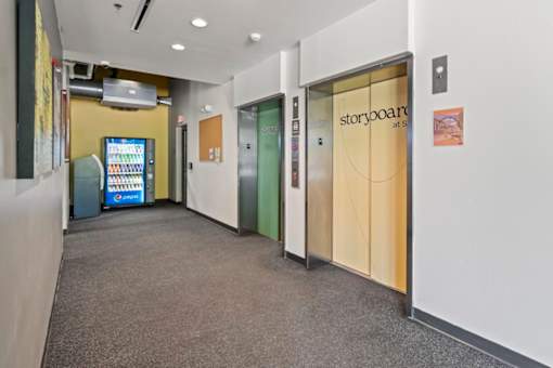 A hallway with a sign that says Storyboard at the top of the stairs.