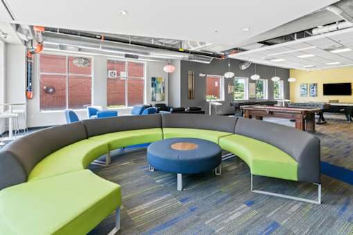 A modern office space with a circular seating arrangement and a long table.