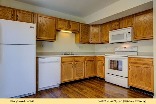 A kitchen with wooden cabinets and white appliances.