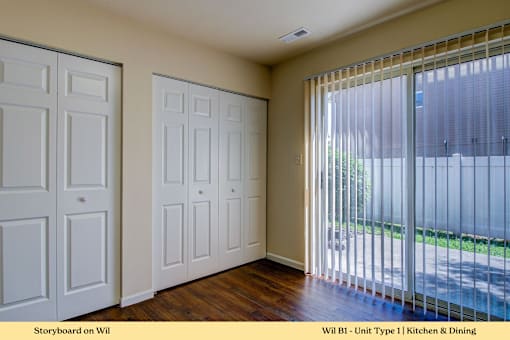 A kitchen and dining room with white doors and a sliding glass door.