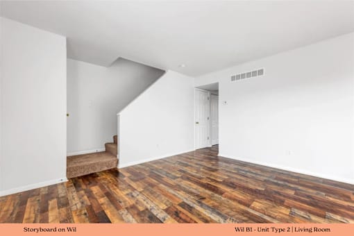 A living room with wooden floors and white walls.