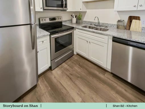a kitchen with stainless steel appliances and white cabinets