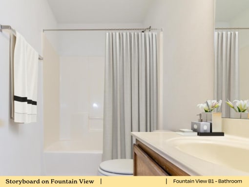 a bathroom with a sink and a tub and a shower