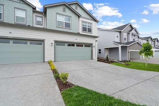 A house with two garages and a driveway.