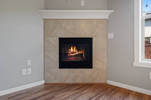 A fireplace with a fire burning inside it.