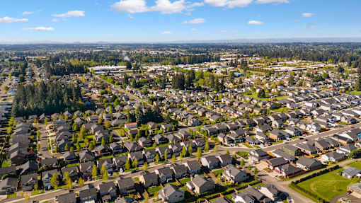 A suburban neighborhood with rows of houses and a park.