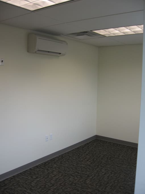 an empty room with a stapler on the floor