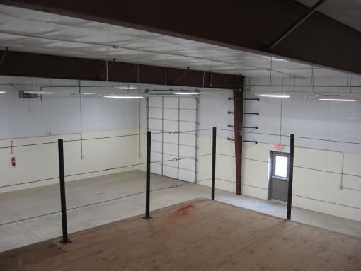 a large room with white walls and poles