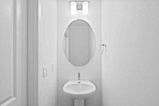 A white sink in a small bathroom.