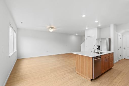 A kitchen with a wooden island and stainless steel appliances.