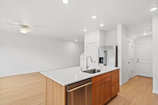 A kitchen with wooden cabinets and a white countertop.