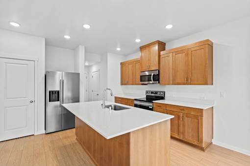 A kitchen with wooden cabinets and a white countertop.