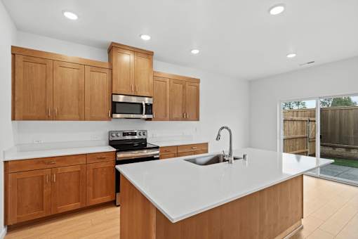A kitchen with wooden cabinets and a white countertop.