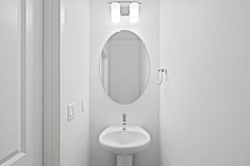 A white sink in a small bathroom.