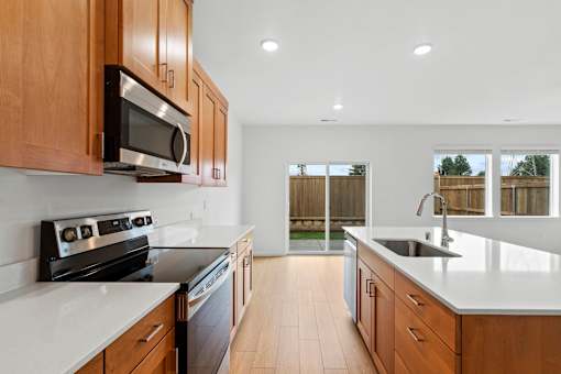 A kitchen with wooden cabinets and white countertops.